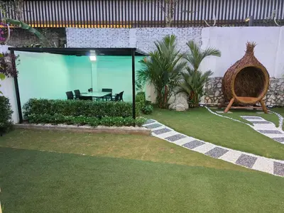 a patio with a table in a large glass room at Bungalow Perkasa in Kuala Lumpur