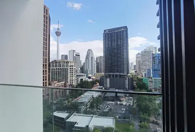 a view of the city from the balcony of a building at Quill Luxe Stay - KLCC in Kuala Lumpur