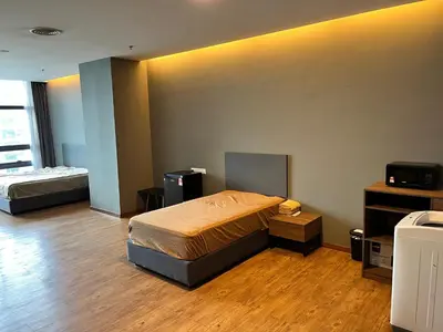 a bedroom with two beds and a television in it at Mid Valley & The Sphere BTC in Kuala Lumpur