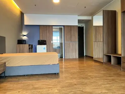 a large room with a bed and wooden cabinets at Mid Valley & The Sphere BTC in Kuala Lumpur