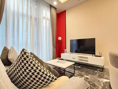 a living room with a couch and a tv at Royce Residences KLCC by WSD in Kuala Lumpur