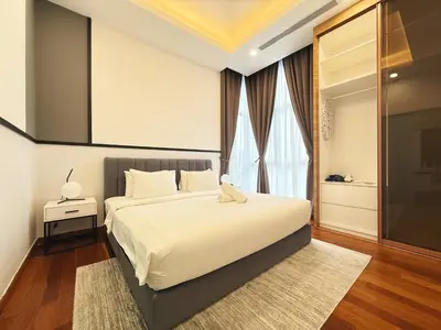 a bedroom with a large bed and a window at Royce Residences KLCC by WSD in Kuala Lumpur