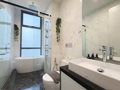 a bathroom with a tub and a toilet and a sink at Royce Residences KLCC by WSD in Kuala Lumpur
