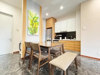 a kitchen with a wooden table and chairs at Royce Residences KLCC by WSD in Kuala Lumpur