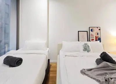 two beds in a room with white sheets and towels at Kuala Lumpur Bintang Fairlane #157 TRX in Kuala Lumpur
