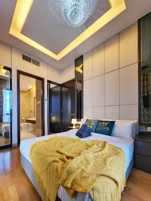 a bedroom with a large bed and a chandelier at Dorsett Residence Kuala Lumpur #08 TRX KLCC Pavilion in Kuala Lumpur