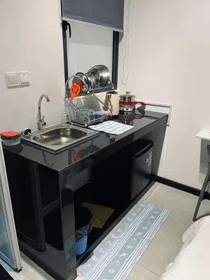 a kitchen counter with a sink in a room at Neu Suites Studio Home Stay in Kuala Lumpur