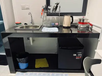 a kitchen counter top with a sink and a counter top at Neu Suites Studio Home Stay in Kuala Lumpur