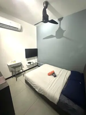 a bedroom with a bed and a ceiling fan at Neu Suites Studio Home Stay in Kuala Lumpur