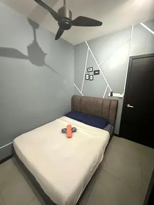 a room with a bed with an orange object on it at Neu Suites Studio Home Stay in Kuala Lumpur