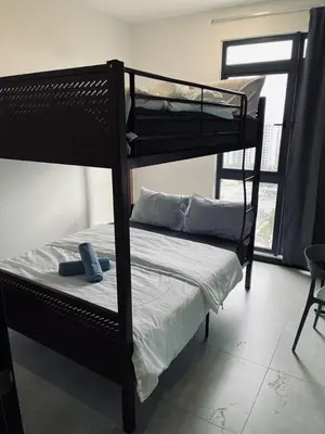 two bunk beds in a room with a window at Neu Suites 2 Bedroom Family Suites in Kuala Lumpur