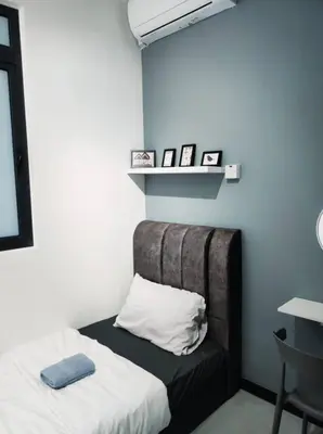 a room with a bed with a pillow and a shelf at Neu Suites 2 Bedroom Family Suites in Kuala Lumpur