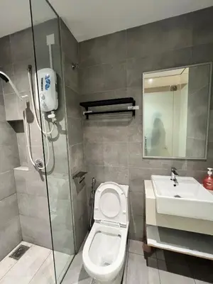 a bathroom with a shower and a toilet and a sink at Reveria city KL in Kuala Lumpur