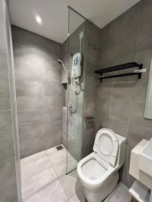 a bathroom with a shower stall and a toilet at Reveria city KL in Kuala Lumpur