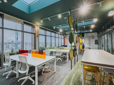 an office with tables and chairs and windows at Reveria city KL in Kuala Lumpur