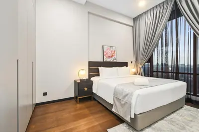a bedroom with a bed and a large window at Atelier 118 Chinatown in Kuala Lumpur