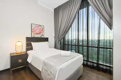 a bedroom with a bed and a large window at Atelier 118 Chinatown in Kuala Lumpur