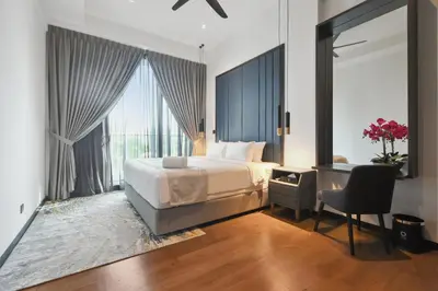 a bedroom with a bed and a desk with a chair at Atelier 118 Chinatown in Kuala Lumpur