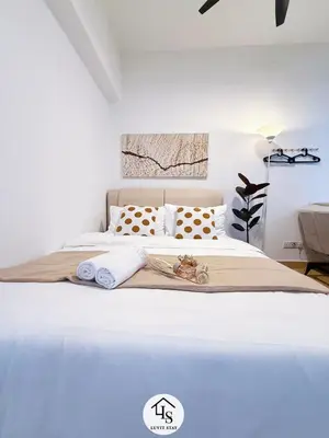 a white bedroom with a large white bed with pillows at Holiday Place by Luvit Stay in Kuala Lumpur