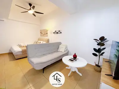 a living room with a couch and a table at Holiday Place by Luvit Stay in Kuala Lumpur
