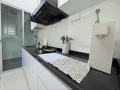 a white kitchen with a counter top with a sink at NEW Minimalist Cozy 3R3B SgBesi - 6 pax in Kuala Lumpur