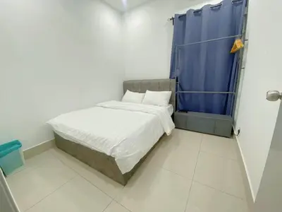 a small bedroom with a bed and a blue curtain at NEW Minimalist Cozy 3R3B SgBesi - 6 pax in Kuala Lumpur