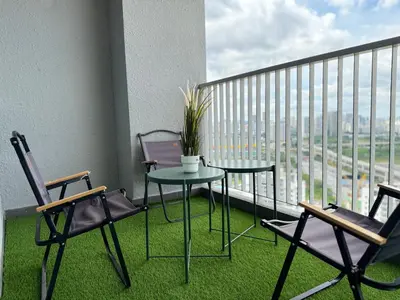 a balcony with a table and chairs on a balcony at NEW Minimalist Cozy 3R3B SgBesi - 6 pax in Kuala Lumpur