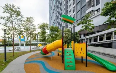 a playground with a slide in a park at Trion KL By HomeTaric Suite in Kuala Lumpur