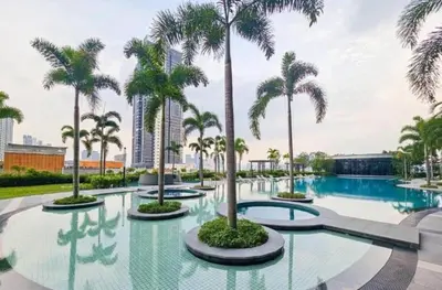 a pool with palm trees in a resort at Trion KL, Jalan Chan Sow Lin, Kuala Lumpur by One Guesthouse in Kuala Lumpur