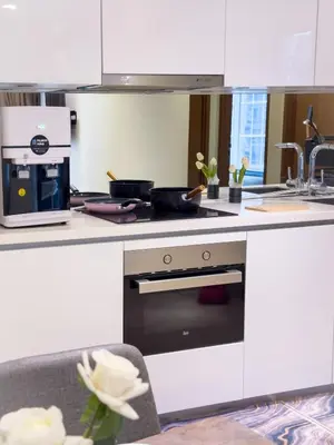 a white kitchen with a stove and a sink at Sky Suites KLCC Premium Stay in Kuala Lumpur