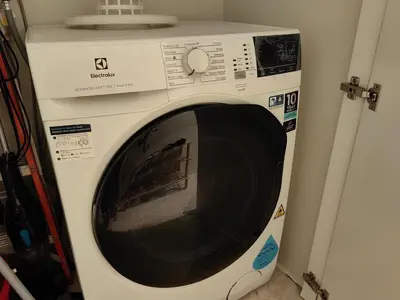 a white washing machine sitting in a room at Sky Suites KLCC Premium Stay in Kuala Lumpur