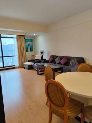 a living room with a couch and a table at Services Star Hotel Suites At Times Square in Kuala Lumpur