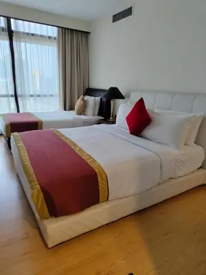 a large bed in a room with two beds at Services Star Hotel Suites At Times Square in Kuala Lumpur