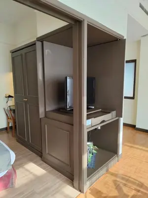 a living room with a closet with a tv and a tv at Services Star Hotel Suites At Times Square in Kuala Lumpur