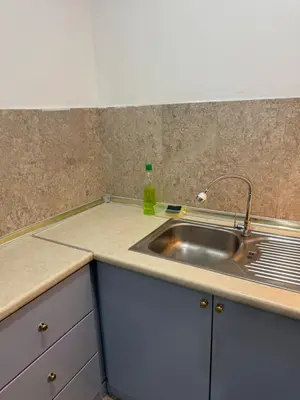 a kitchen counter with a sink and a bottle on it at Services Star Hotel Suites At Times Square in Kuala Lumpur