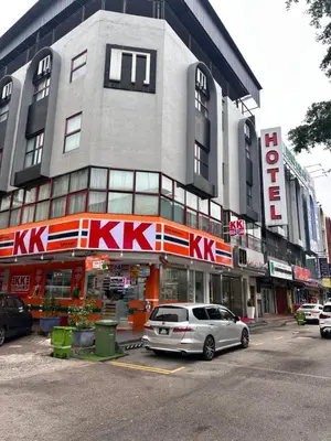 a car parked in a parking lot in front of a building at M Design Hotel @ Shamelin Perkasa in Kuala Lumpur