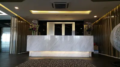 a lobby with a large table in front of a door at M Design Hotel @ Shamelin Perkasa in Kuala Lumpur