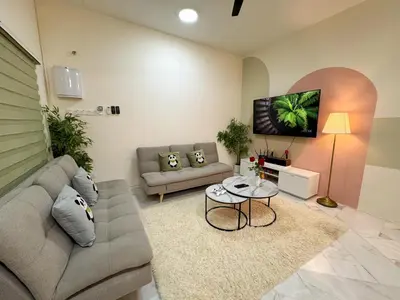 a living room with a couch and a table at Private Pool SemiD 5 Min Walk SunwayVelocity Max 21 Pax in Kuala Lumpur