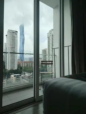 a bedroom with a view of a city from a window at One bukit ceylon Mardeka Tower View in Kuala Lumpur