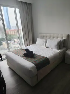 a bed in a room with a large window at One bukit ceylon Mardeka Tower View in Kuala Lumpur