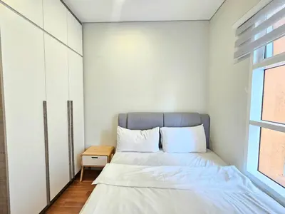 a small bedroom with a bed and a window at The Sky Suites KLCC by the Park in Kuala Lumpur