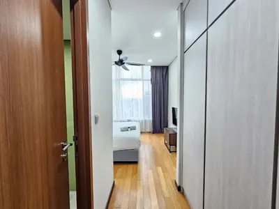a room with a bedroom with a bed and a window at The Sky Suites KLCC by the Park in Kuala Lumpur