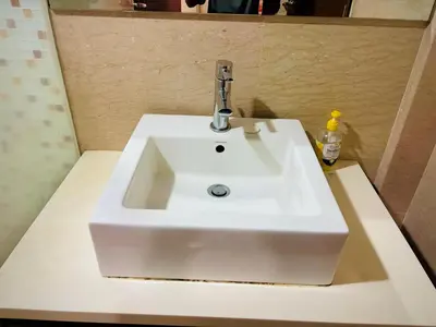 a white bathroom sink with a faucet on a counter at Regalia Skypool KLCC Friendly Hostel in Kuala Lumpur