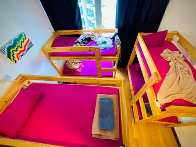 two bunk beds in a room with pink sheets at Regalia Skypool KLCC Friendly Hostel in Kuala Lumpur