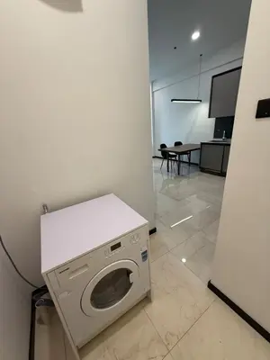 a washer and dryer sitting in a room at Opus Residence in Kuala Lumpur