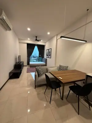 a living room with a table and a couch at Opus Residence in Kuala Lumpur