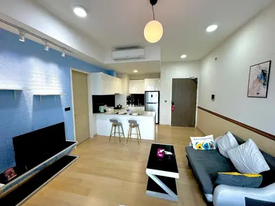 a living room with a couch and a kitchen at The KLCC At Star SKY Pools in Kuala Lumpur