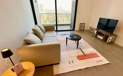a living room with a couch and a television at The Establishment Bangsar #19 by Ouki in Kuala Lumpur