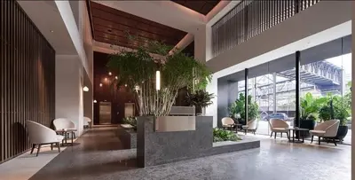 a lobby with chairs and plants in a building at The Establishment Bangsar #19 by Ouki in Kuala Lumpur