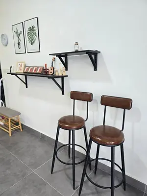 two bar stools in front of a white wall at Sentrio Pandan KL KLCC View Kuala Lumpur 37 in Kuala Lumpur